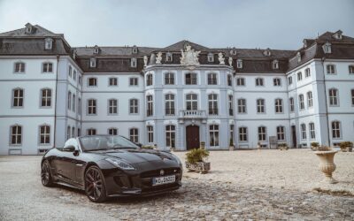 black sports coupe near building