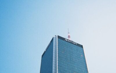 Modern skyscraper in Warsaw against a clear sky, showcasing urban architecture.