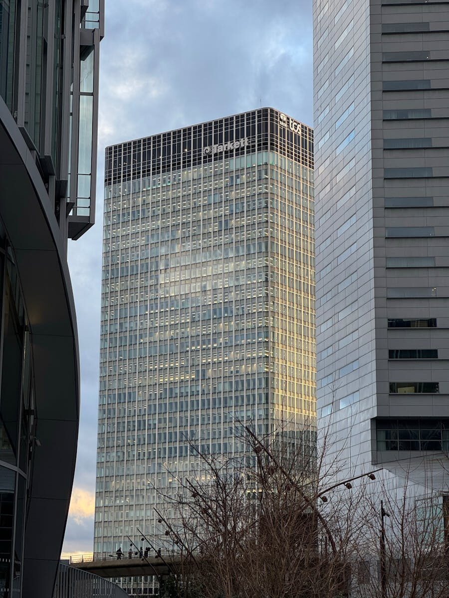 A towering skyscraper in Paris's La Défense district captured from the ground level.