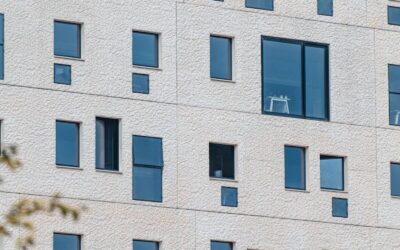 A tall white building with lots of windows