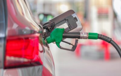 a gas pump is connected to a car at a gas station