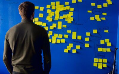 man in gray long sleeve shirt standing in front of blue and yellow puzzle mat
