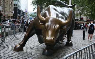 a statue of a bull on a brick street