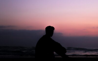 silhoutte of man sitting on ground