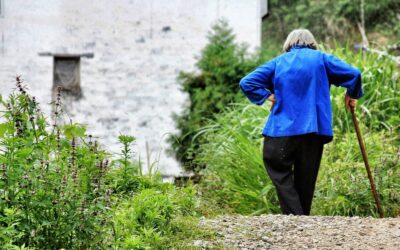 woman walking while holding walking cane