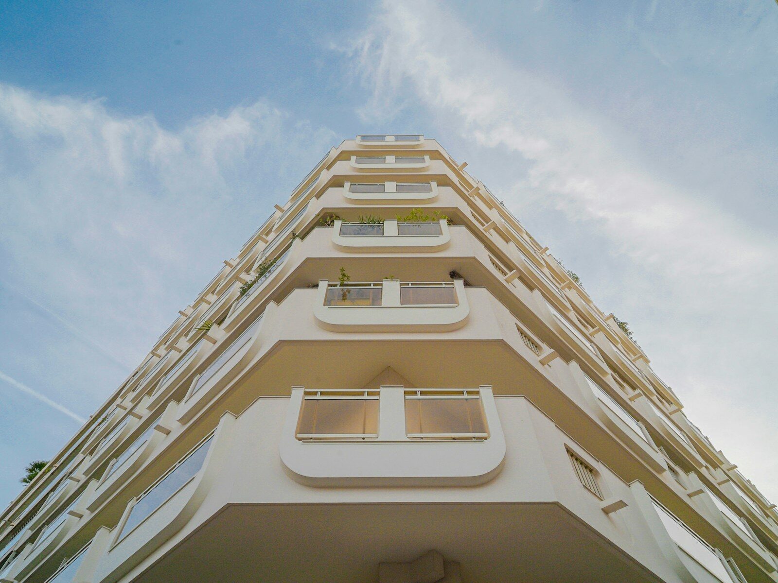 Modern apartment building viewed from below against sky