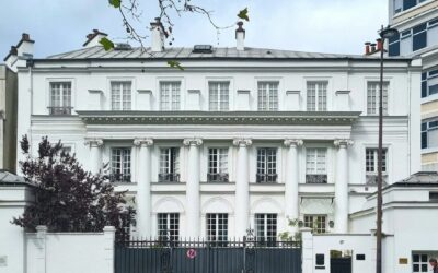 A large white building with a black gate