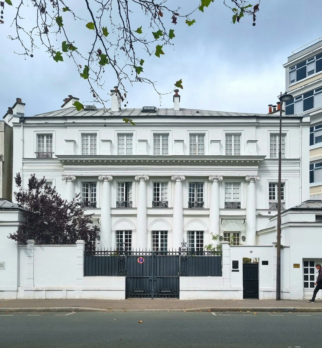 A large white building with a black gate