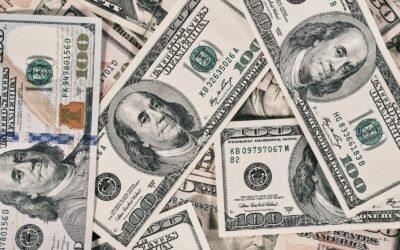 a pile of twenty dollar bills laying on top of each other