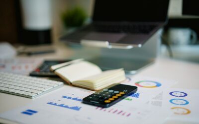 office desk with smartphone and financial charts