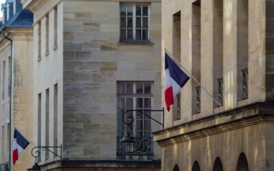 a building with two flags flying in front of it