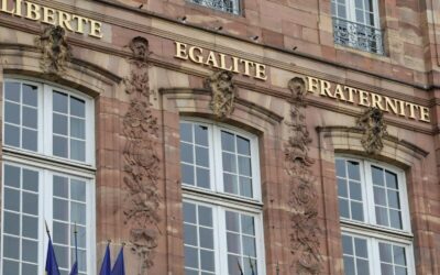Stone building with french flags and motto