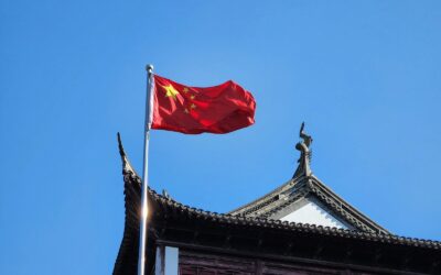 A chinese flag flying on top of a building