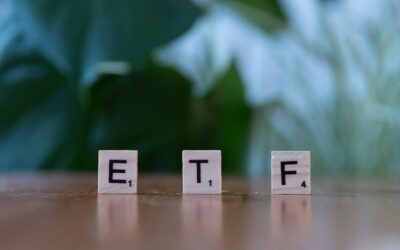 A wooden block spelling the word etf on a table