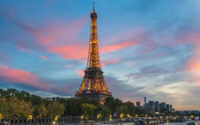 the eiffel tower is lit up at night