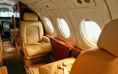 Tan leather seats with quilted stitching inside a private jet cabin